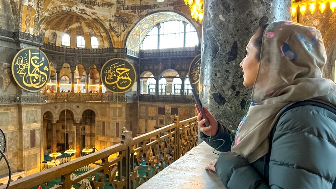 Visitor using audio guide inside Hagia Sophia, Istanbul.
