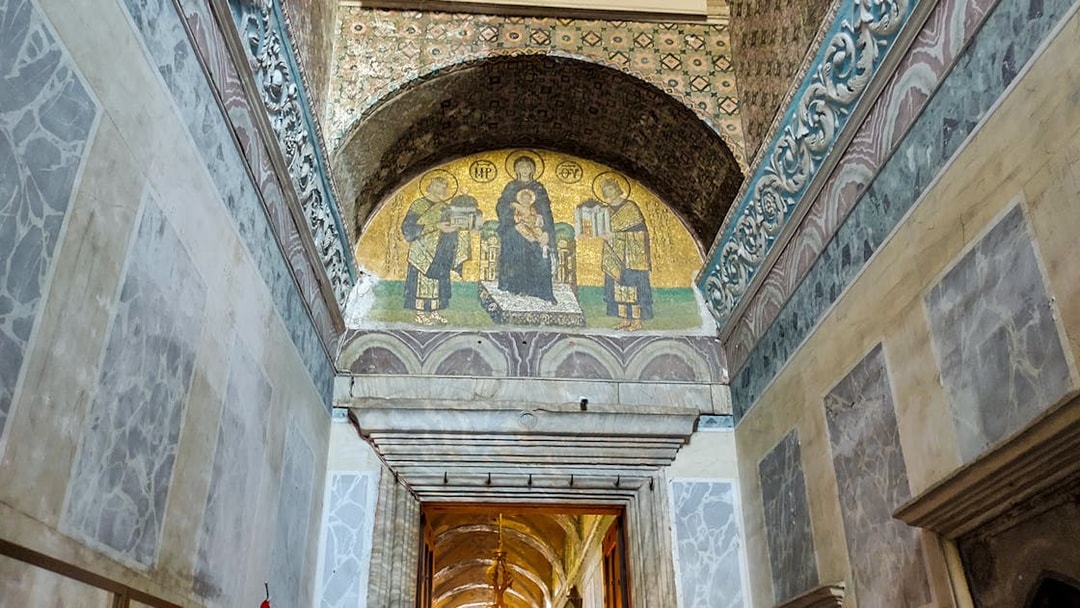 Hagia Sophia entrance door with mosaic above leading to prayer hall.