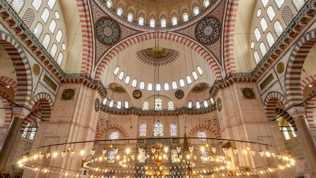 Interior of Blue Mosque with ornate domes and stained glass windows, Istanbul.