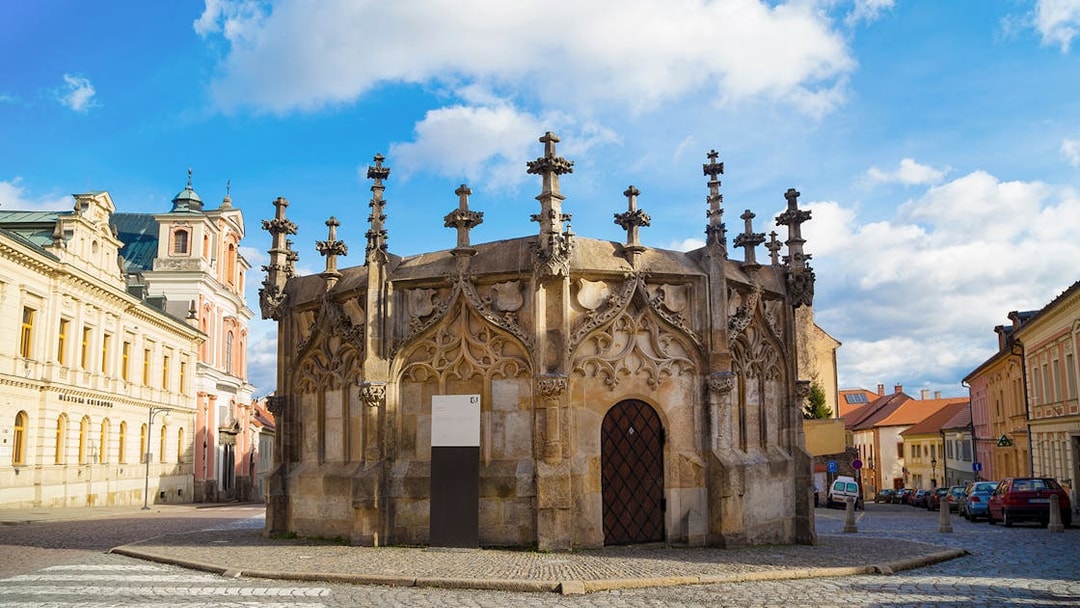 Gothic Stone Fountain in Kutna Hora, Czech Republic, on a cobblestone street.