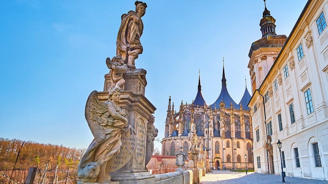 Statues and St. Barbara's Church in Kutna Hora on a sunny day.