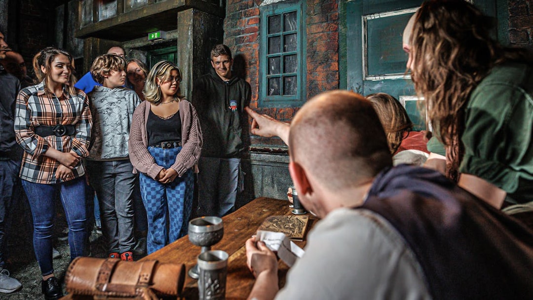 Visitors engaged in an interactive experience at Hamburg Dungeon.