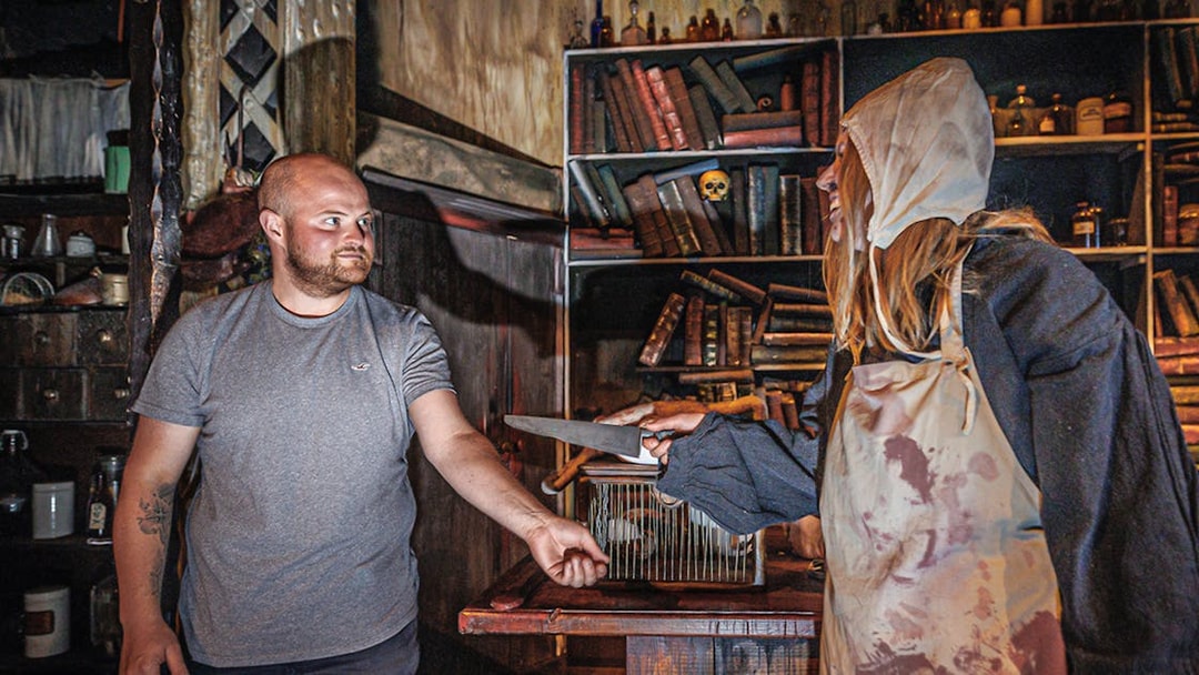 Man interacting with plague doctor in Hamburg Dungeon scene.