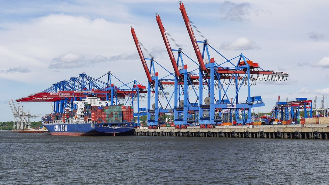 Container ship at Hamburg port near Elbphilharmonie during guided tour.