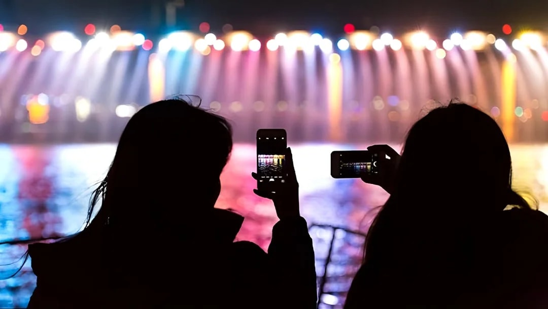 Silhouettes capturing Banpo Bridge rainbow fountain on Han River Marina Yacht.
