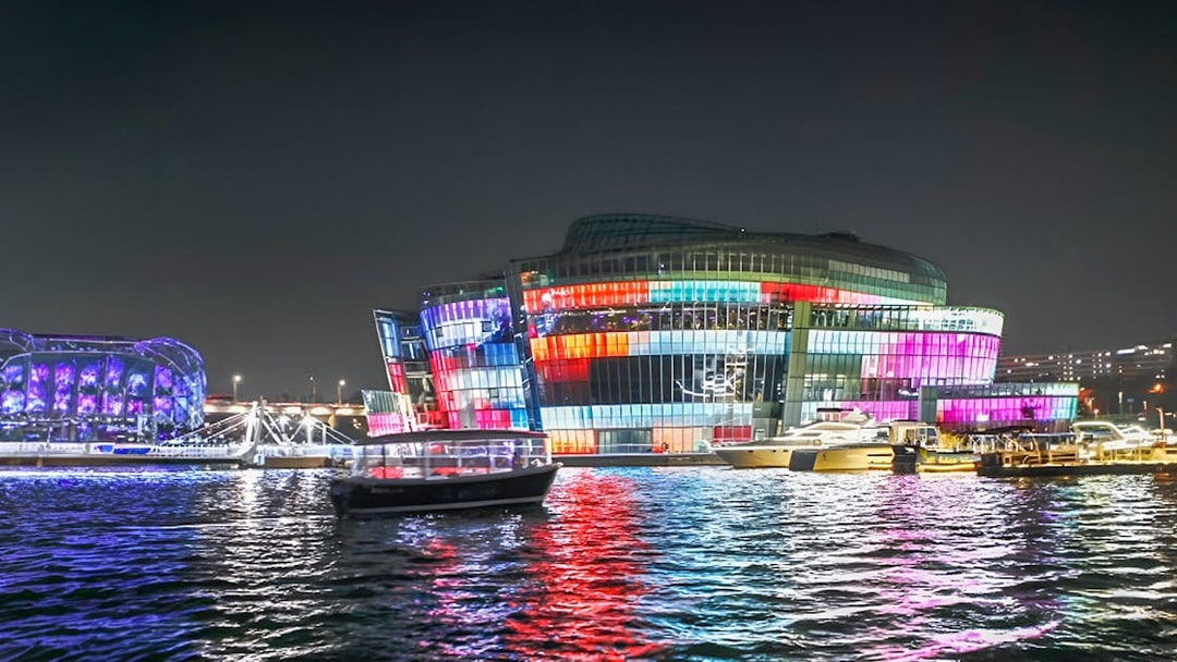 Yachts on Han River at night with colorful lights, Seoul Golden Blue Marina.