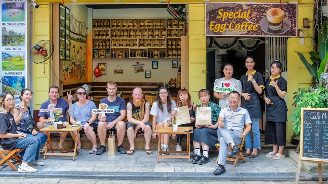 Group enjoying egg coffee at a Hanoi café during guided city tour.