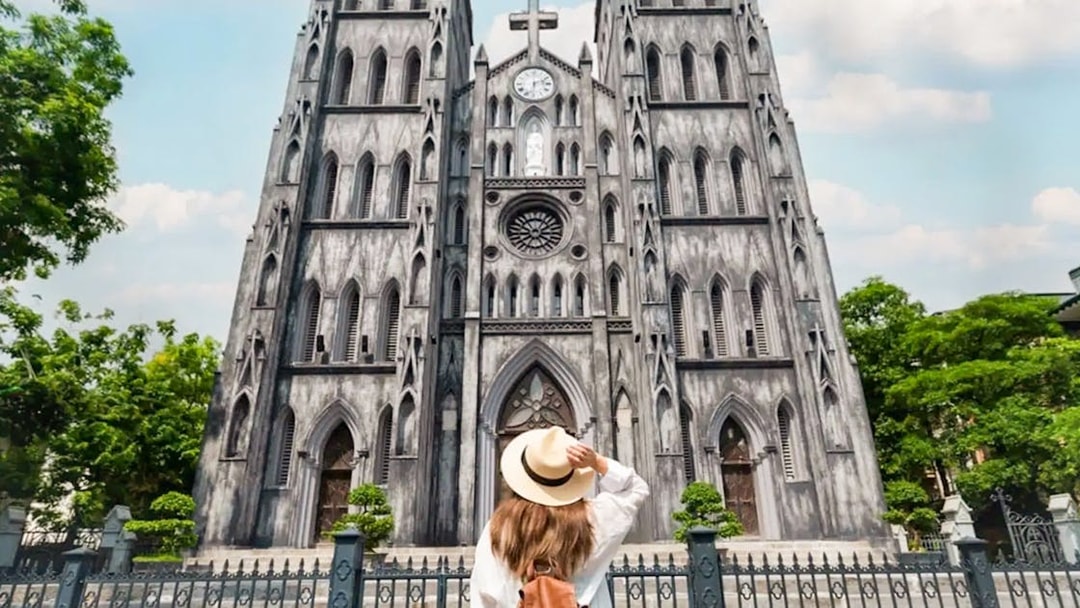 Woman admiring St. Joseph's Cathedral in Hanoi on a guided half-day city tour.