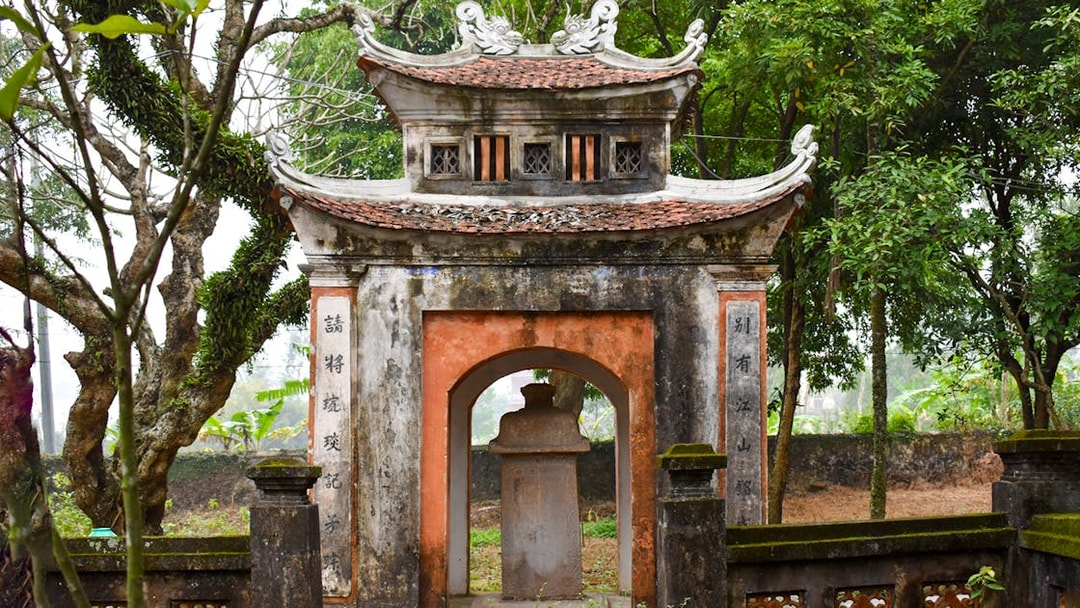 Ancient gate at Hoa Lu, surrounded by lush greenery, part of the Day Tour Hoa Lu-Tam Coc.
