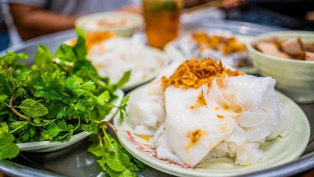 Traditional Vietnamese dish with rice noodles and herbs on a plate, Day Tour Hoa Lu-Tam Coc.