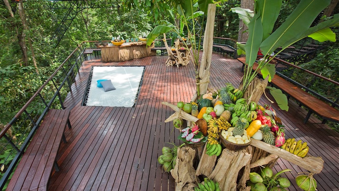 Fruit display and seating area on a wooden deck at Hanuman World, Phuket.