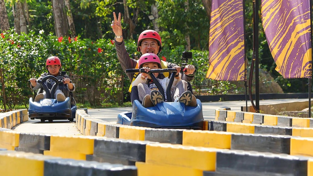 Zipline participants enjoying a go-kart ride at Hanuman World, Thailand.