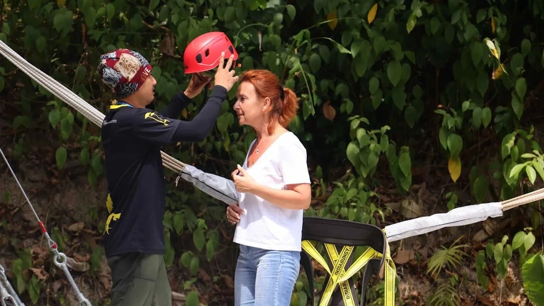 Safety briefing with helmet fitting at Hanuman World, Thailand.