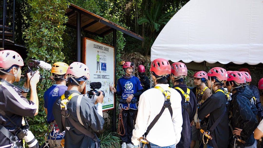Safety briefing at Hanuman World with group wearing helmets and harnesses.
