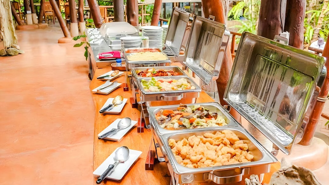 Buffet spread at Hanuman World with various dishes and cutlery.