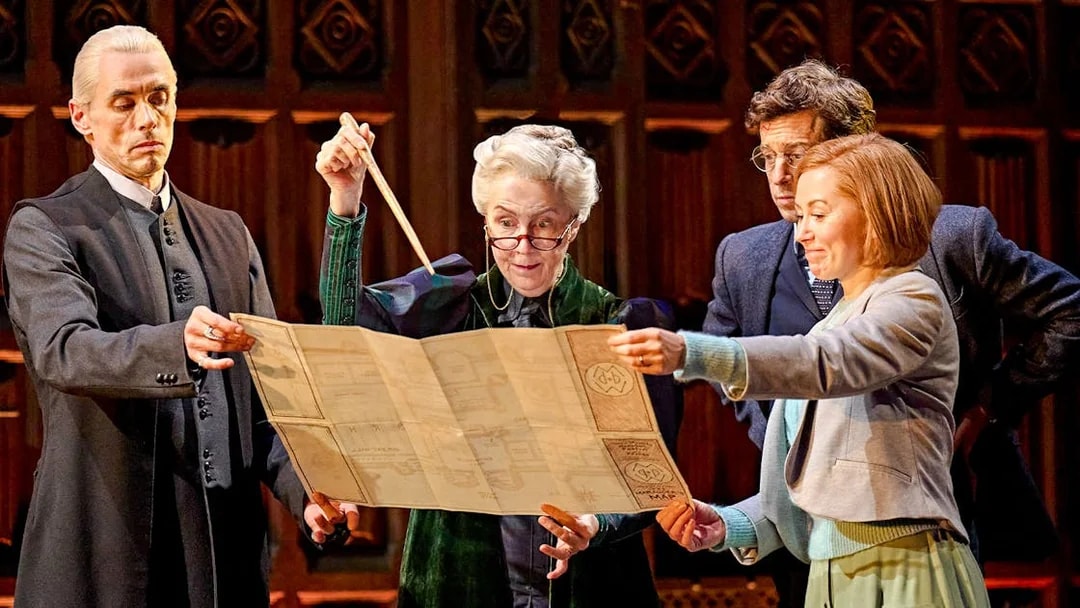 Actors on stage examining a map in "Harry Potter and the Cursed Child" play.