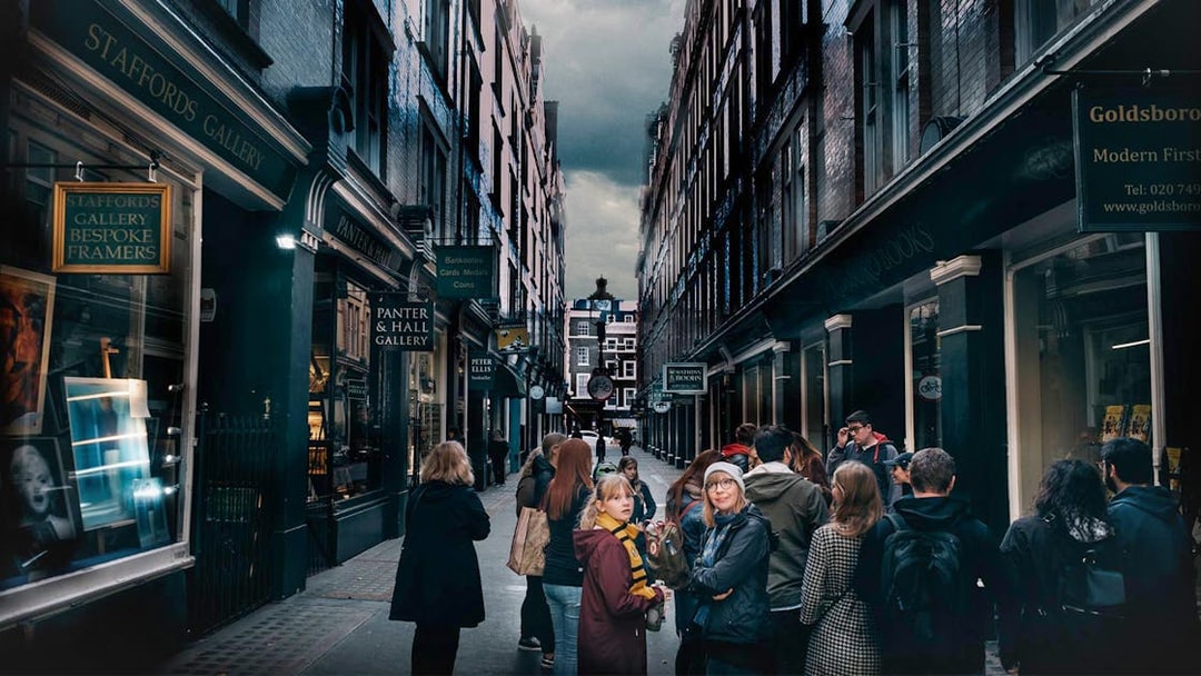 Visitors exploring Harry Potter film locations in a narrow London alley.