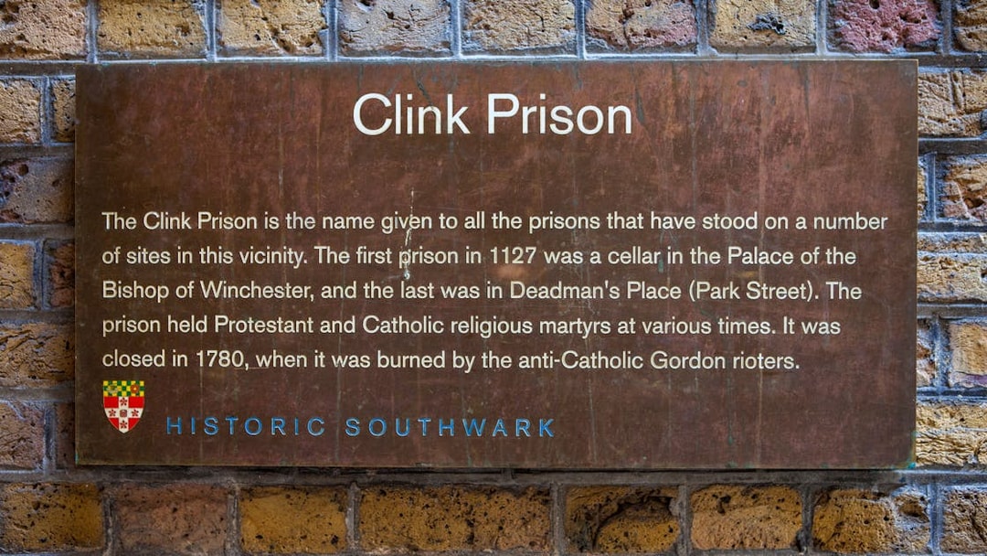 Clink Prison sign detailing its history, featured on a Harry Potter film location tour during a Thames Boat Cruise.