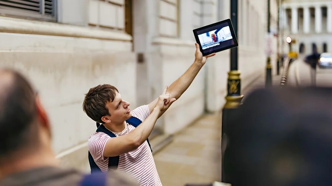 Guide showing Harry Potter film location on tablet during walking tour.