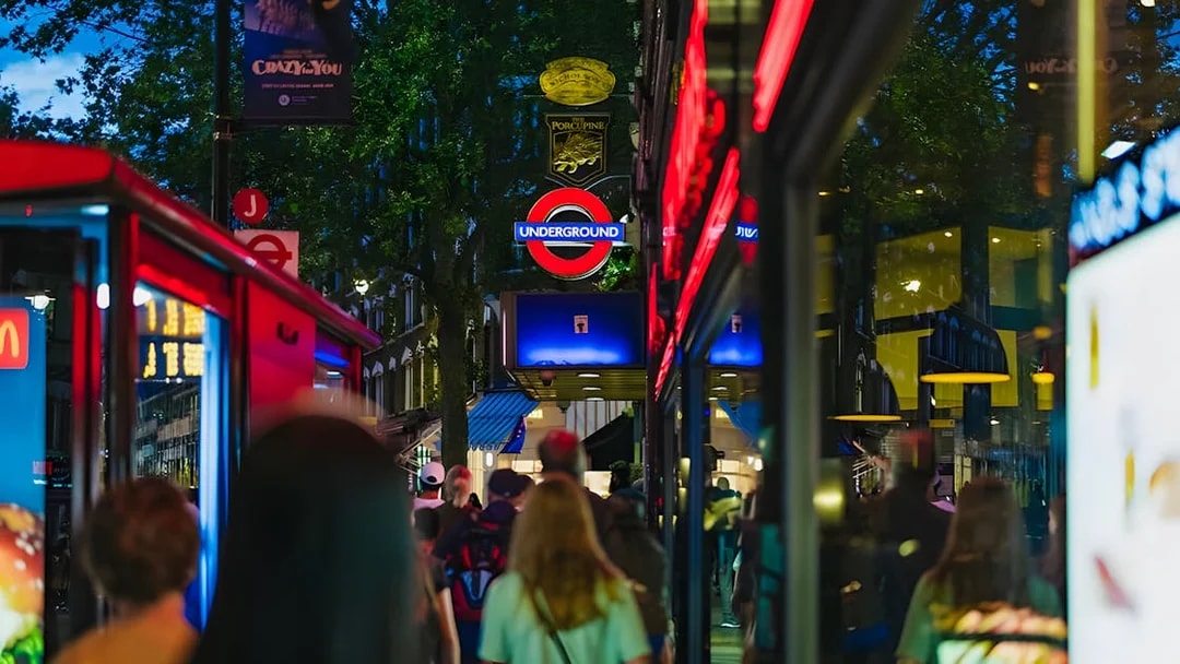Crowd walking near London Underground sign on Harry Potter film locations tour.