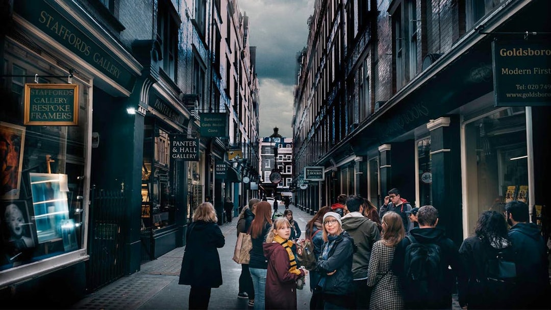 Visitors exploring Harry Potter film locations in London alleyway.