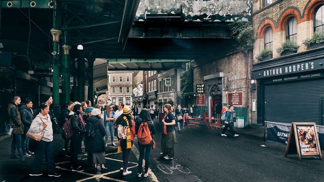 Group of tourists at Borough Market, a Harry Potter film location in London.