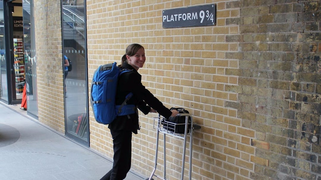 Person with luggage cart at Platform 9¾, King's Cross, London, on Harry Potter bus tour.