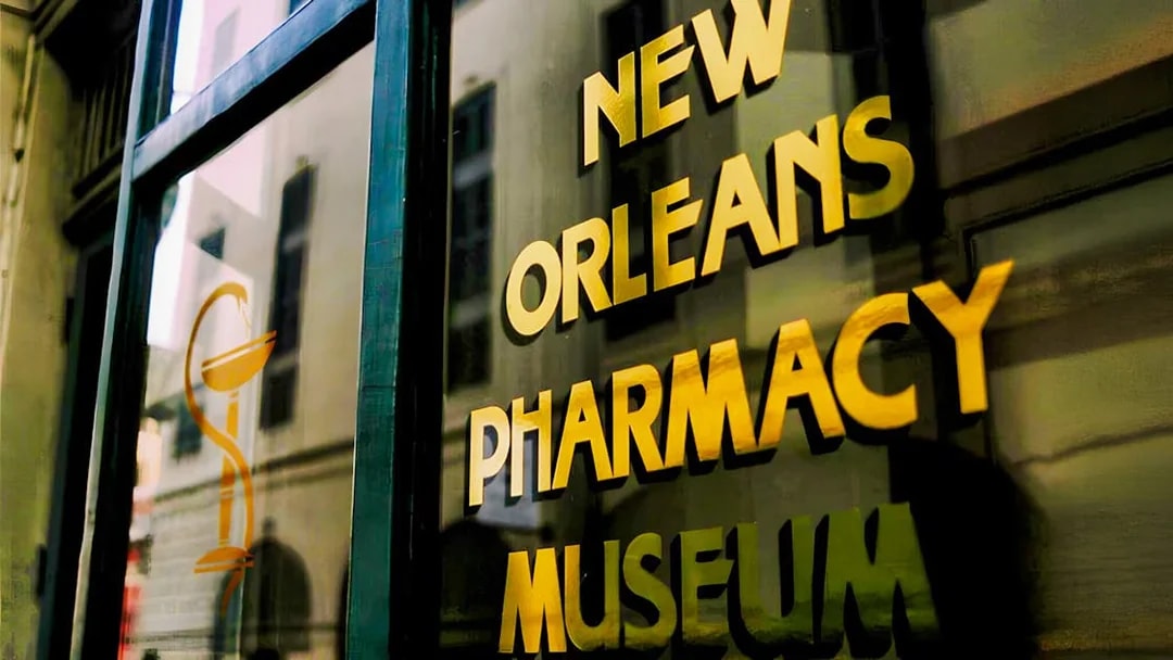 New Orleans Pharmacy Museum sign reflecting historic building.