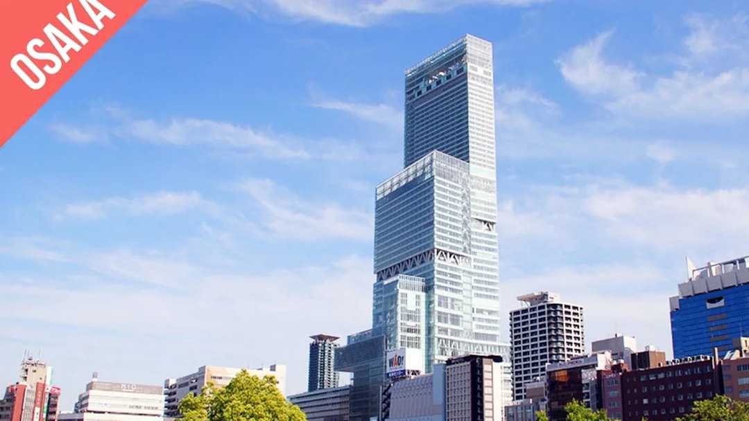 Abeno Harukas skyscraper in Osaka under a clear blue sky.