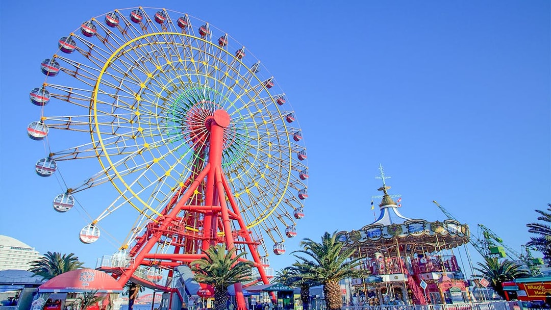 Ferris wheel and carousel at an amusement park in Kansai, Japan.