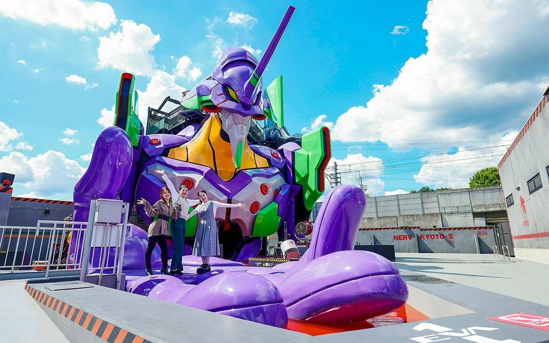 Visitors posing with a giant robot statue at TOEI Kyoto Studio Park.