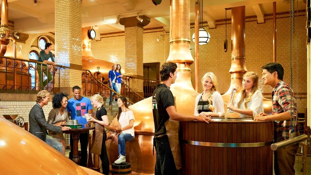 Visitors enjoying a tour inside the Heineken brewery, Amsterdam.