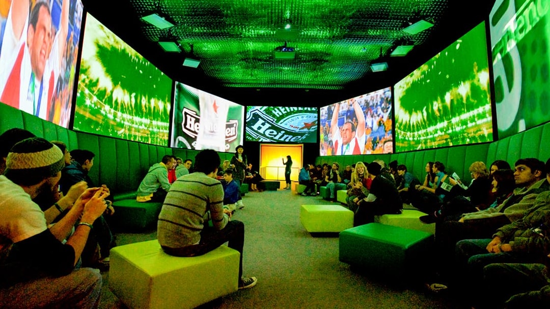 Guests at Heineken Experience in Amsterdam enjoying interactive exhibits and tasting area.