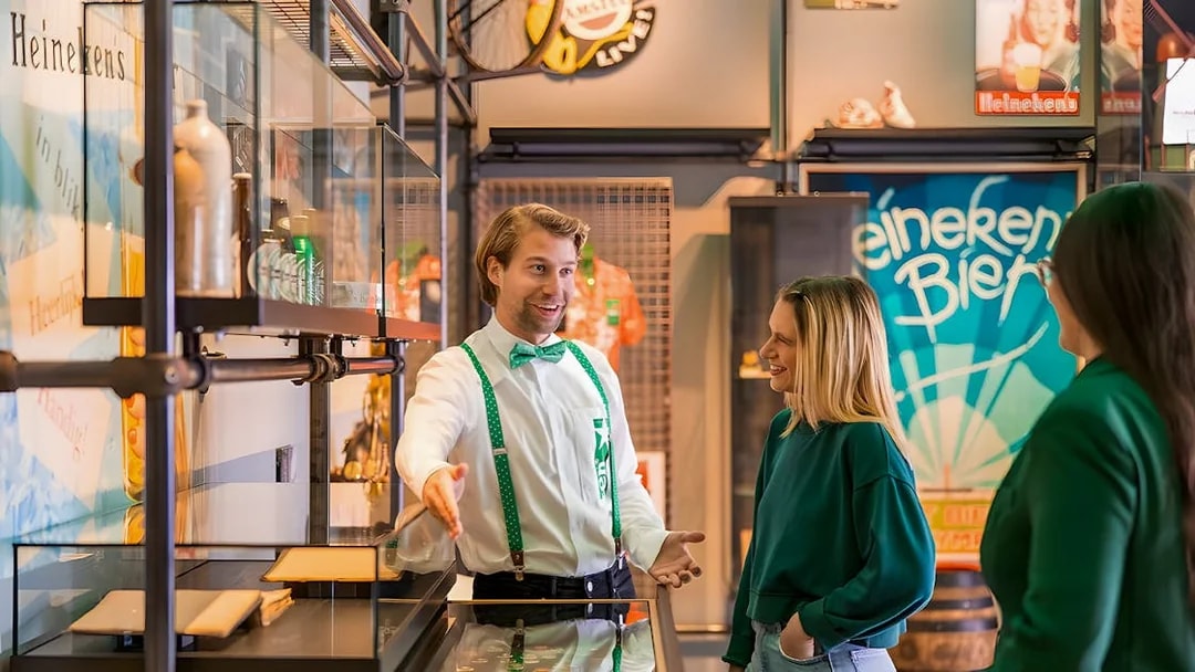 Guests interacting with a guide at the Heineken Experience in Amsterdam.