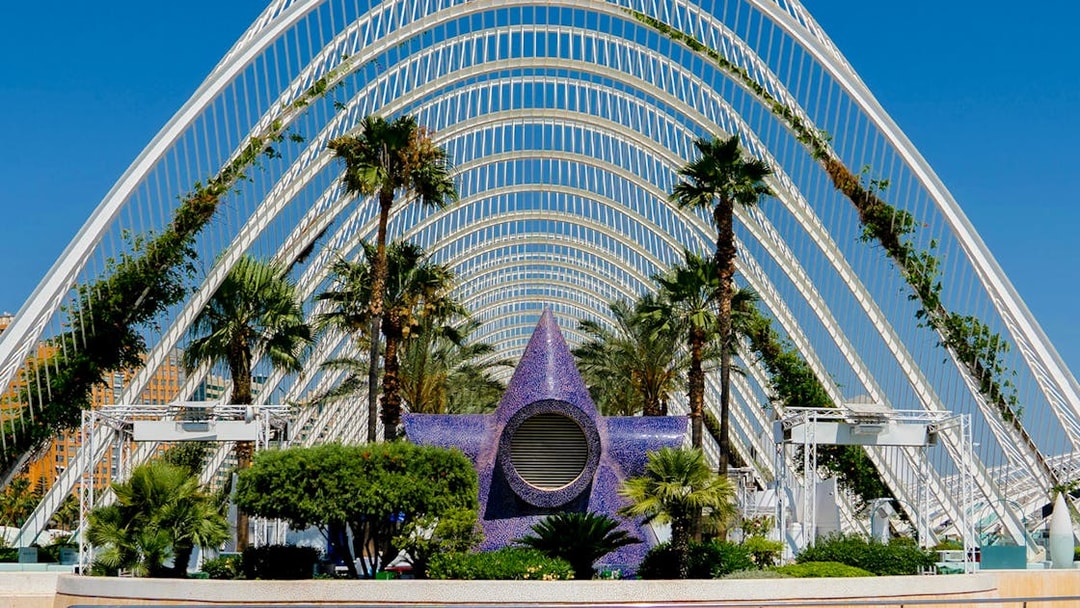 Hemisfèric architecture with palm trees and pool in City of Arts and Sciences, Valencia.