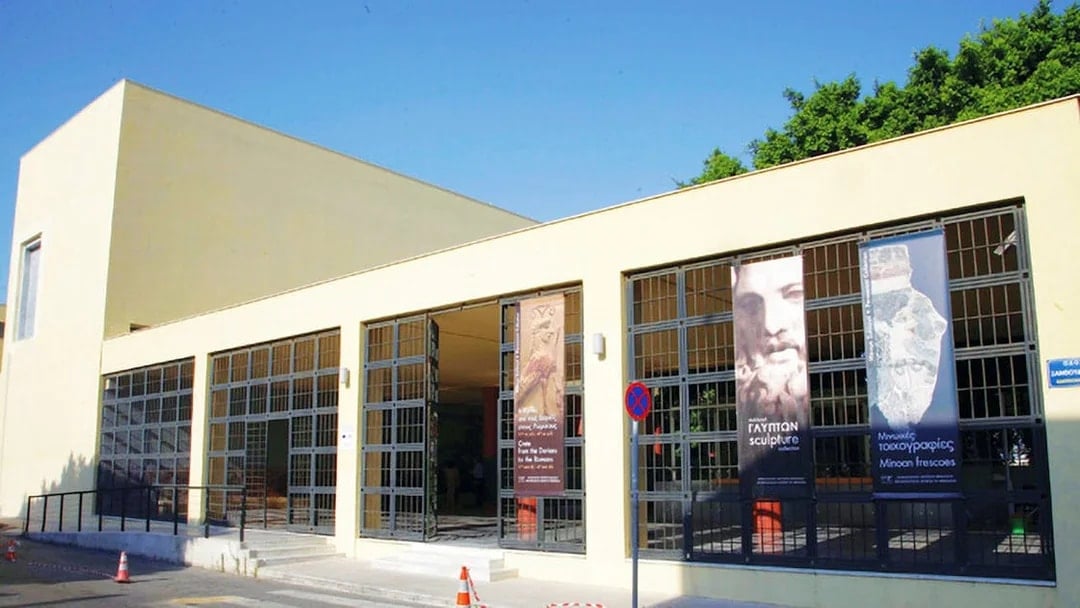 Heraklion Archaeological Museum entrance with banners displaying ancient artifacts.