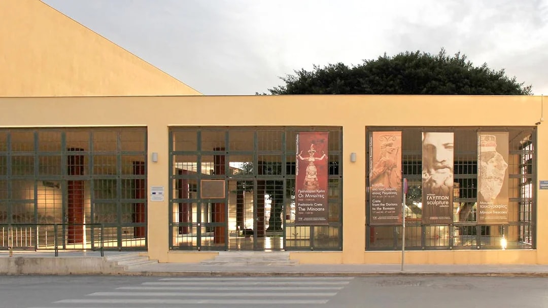 Heraklion Archaeological Museum entrance with banners displaying ancient artifacts.