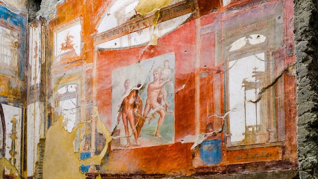 Fresco of Neptune and Aimone on a vibrant wall in Ercolano, showcasing ancient Roman art.