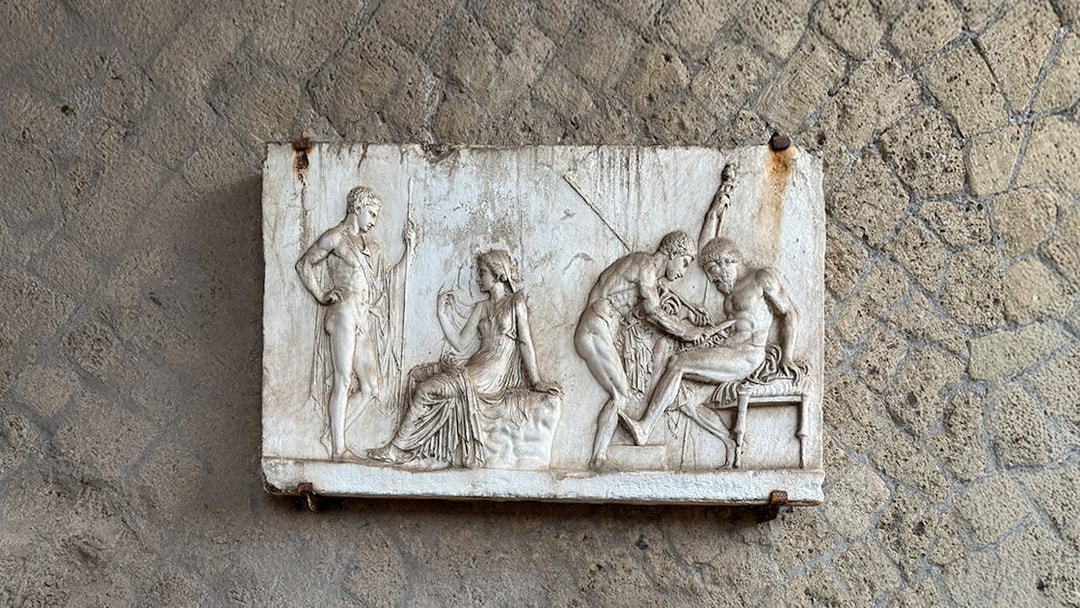 Ancient relief sculpture depicting figures in Herculaneum archives.