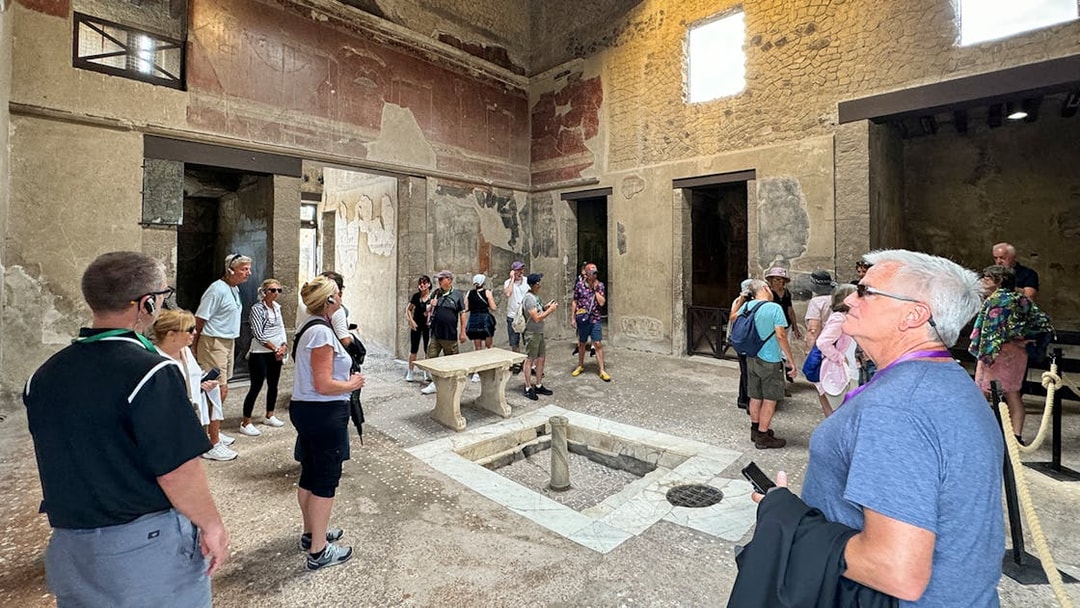 Visitors exploring ancient ruins at Herculaneum, Italy.