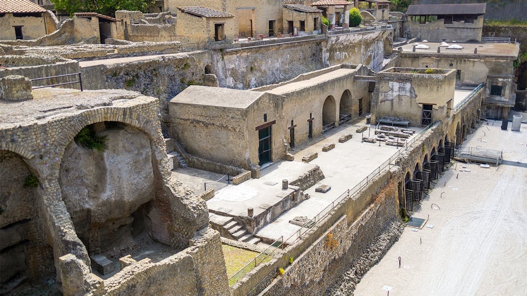 Ancient ruins of the Herculaneum Samnite House with stone arches and preserved structures.