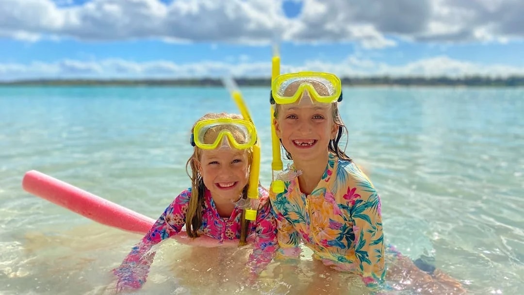 Children snorkeling in clear waters on K'gari (Fraser Island) tour.