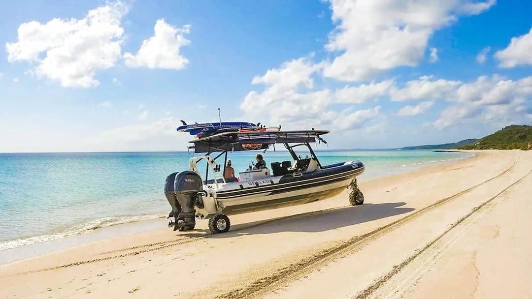 Sealegs boat on K'gari beach, Fraser Island, near turquoise water.