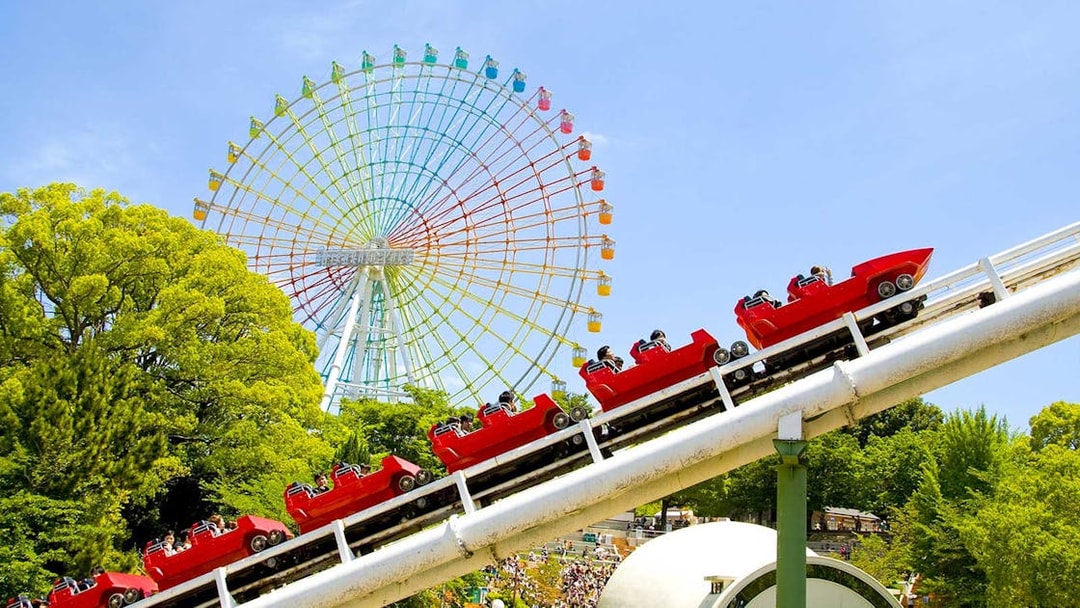 Roller coaster and Ferris wheel at Hirakata Park, Japan.