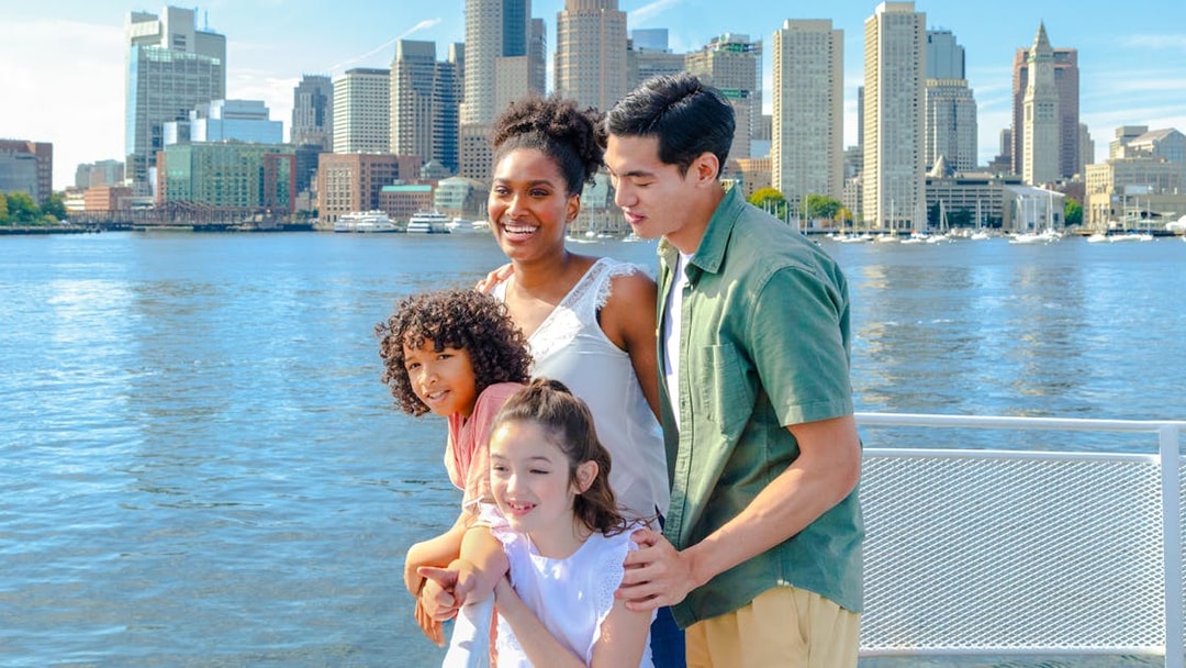 Guests enjoying the view of Boston skyline on a historic harbor cruise.