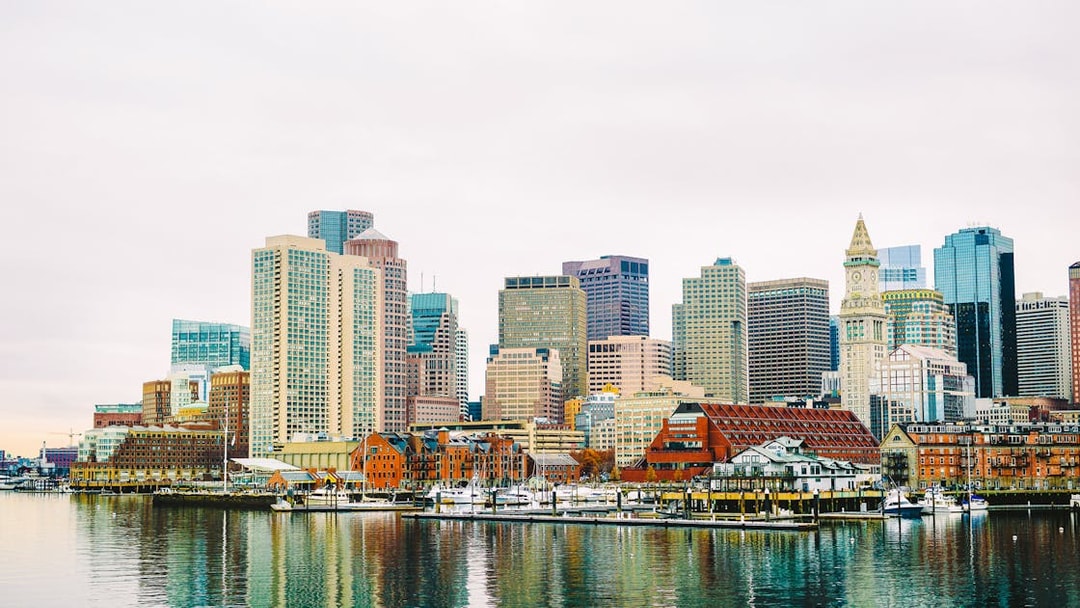 Boston Harbor waterfront skyline with historic and modern buildings.