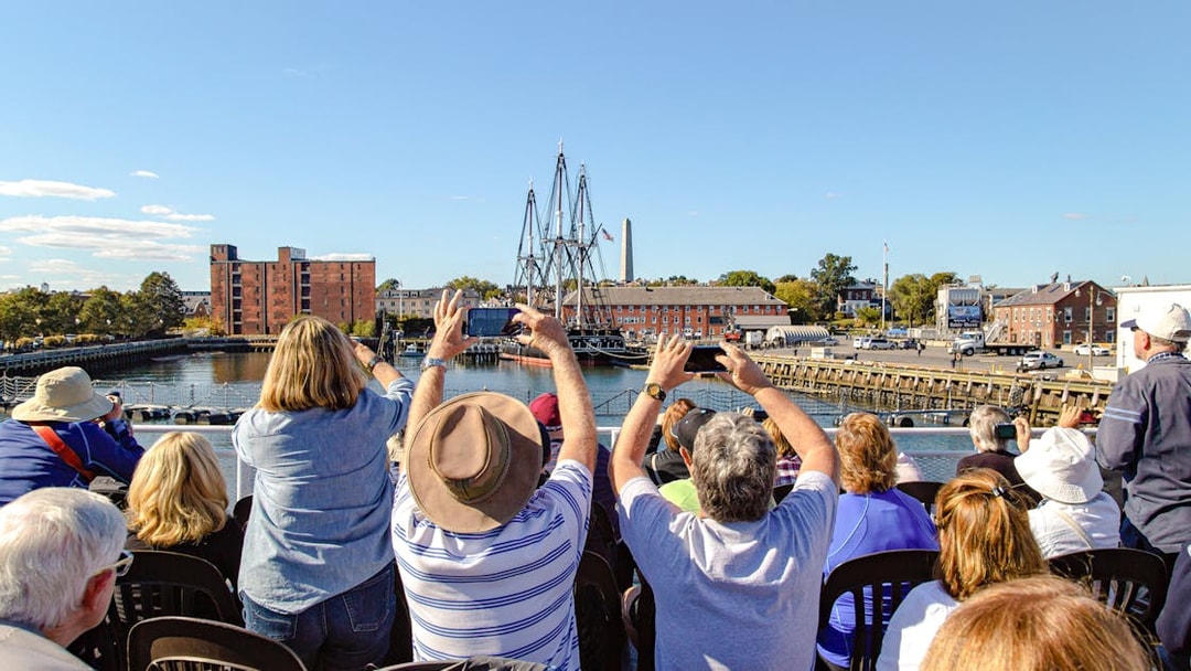 Tourists photographing the USS Constitution in Boston Harbor.