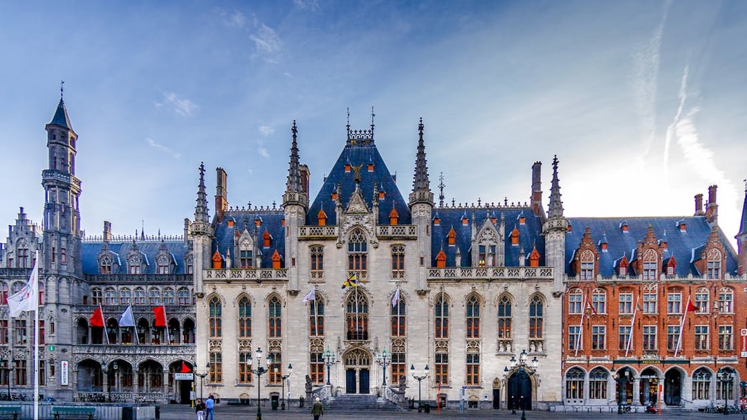 Exterior view of Historium Bruges with Gothic architecture and spires in Bruges, Belgium.