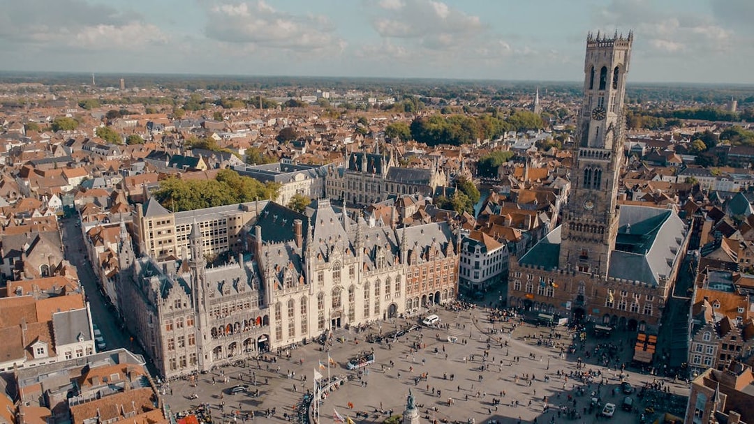Aerial view of Historium Bruges and Belfry tower in Bruges, Belgium.