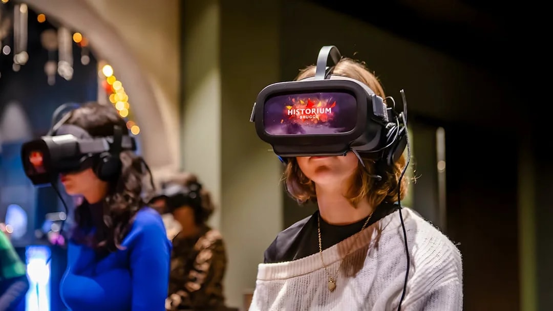 Visitors using VR headsets at Historium Bruges experience.